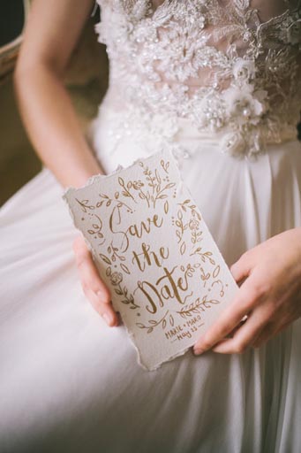 Woman in Wedding Dress Holding Wedding Invitation