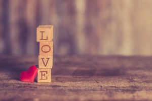 A stack of wooden blocks spelling out the word love.